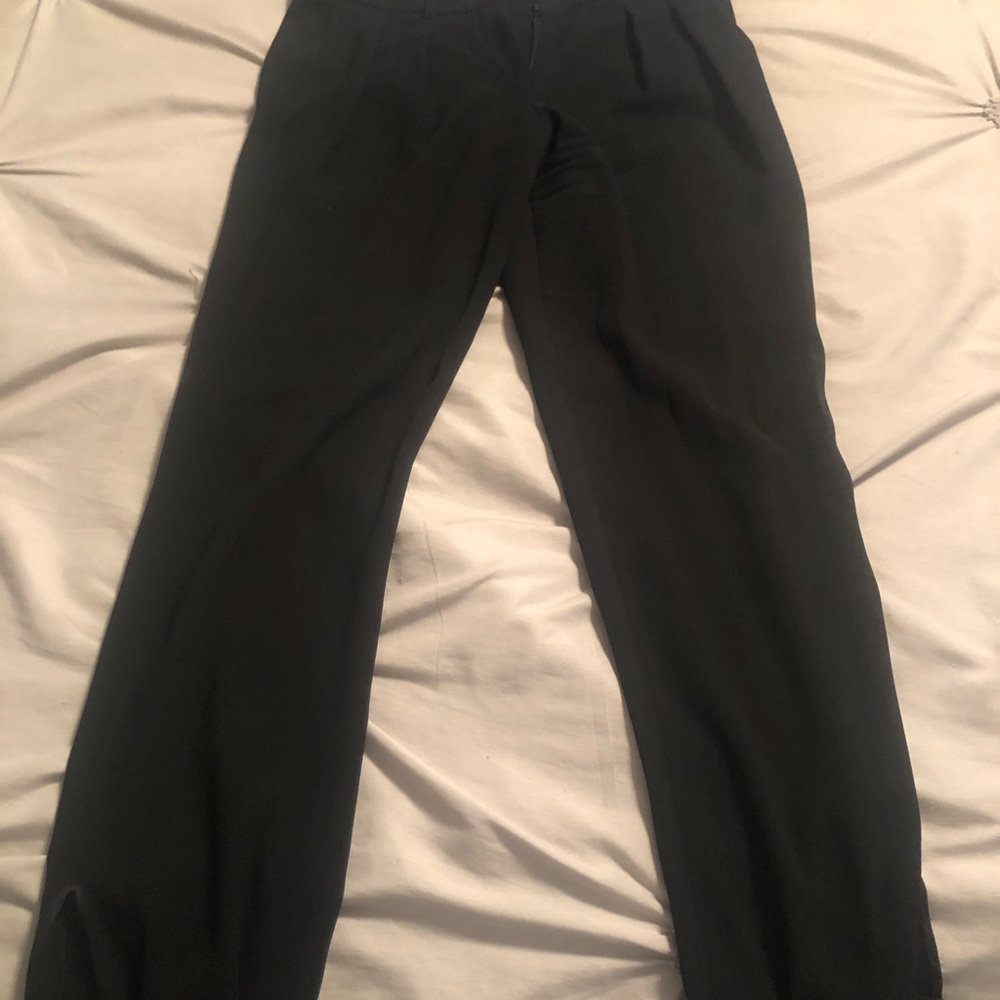 Women’s dress pants with a button at the bottom
